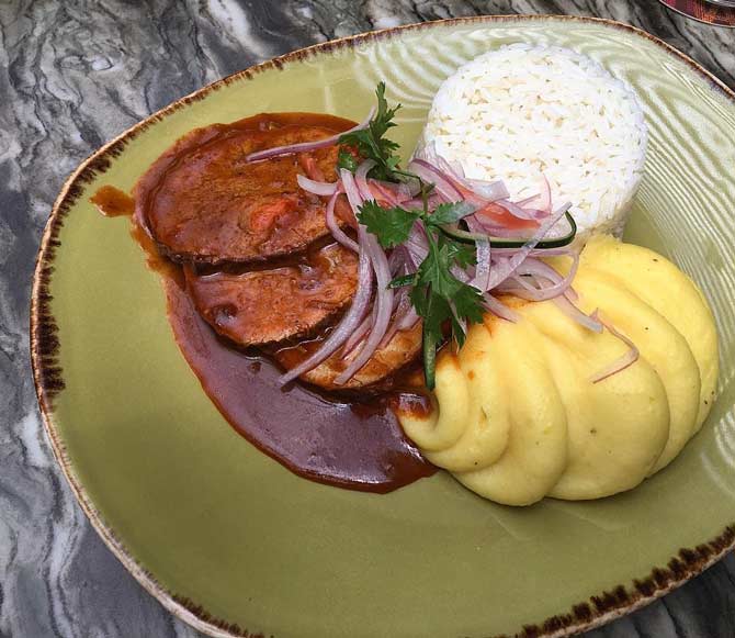 receta de asado de carne peruano acompañado con un porción de arroz y puré